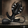 Master Series Ass Lock inflatable anal plug: a black, multi-pronged silicone plug with a hand pump on a wooden table.