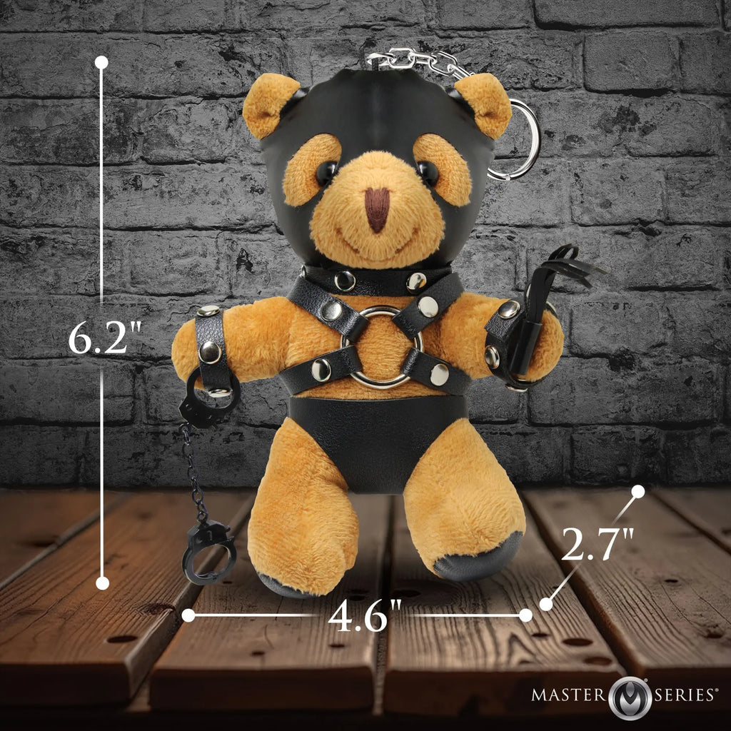 Master Series Master Bear keychain: A tan plush bear in a black leather hood, harness, cuffs, and briefs with a whip.