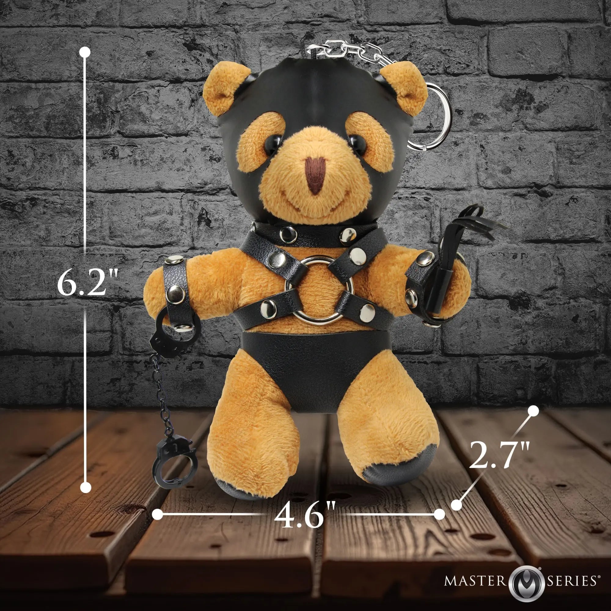 Master Series Master Bear keychain: A tan plush bear in a black leather hood, harness, cuffs, and briefs with a whip.