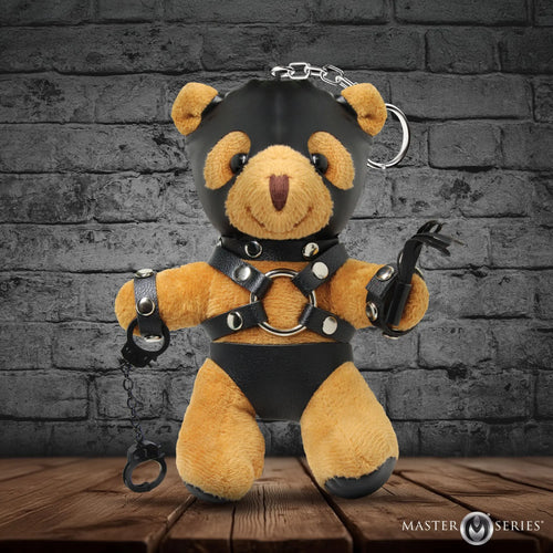 Master Series Master Bear keychain: brown plush bear in black leather hood, harness, and shorts, holding a whip and cuffs.