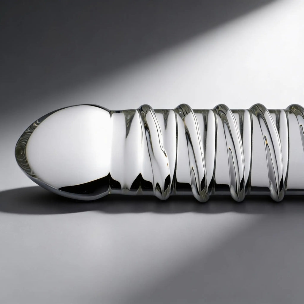 Master Series Behemoth XL dildo, a smooth, silver, metallic-finish toy with a prominent, spiraling ribbed texture.
