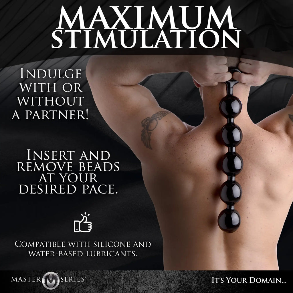Master Series The Black Baller: a person holding a long string of smooth, glossy black anal beads against their back.