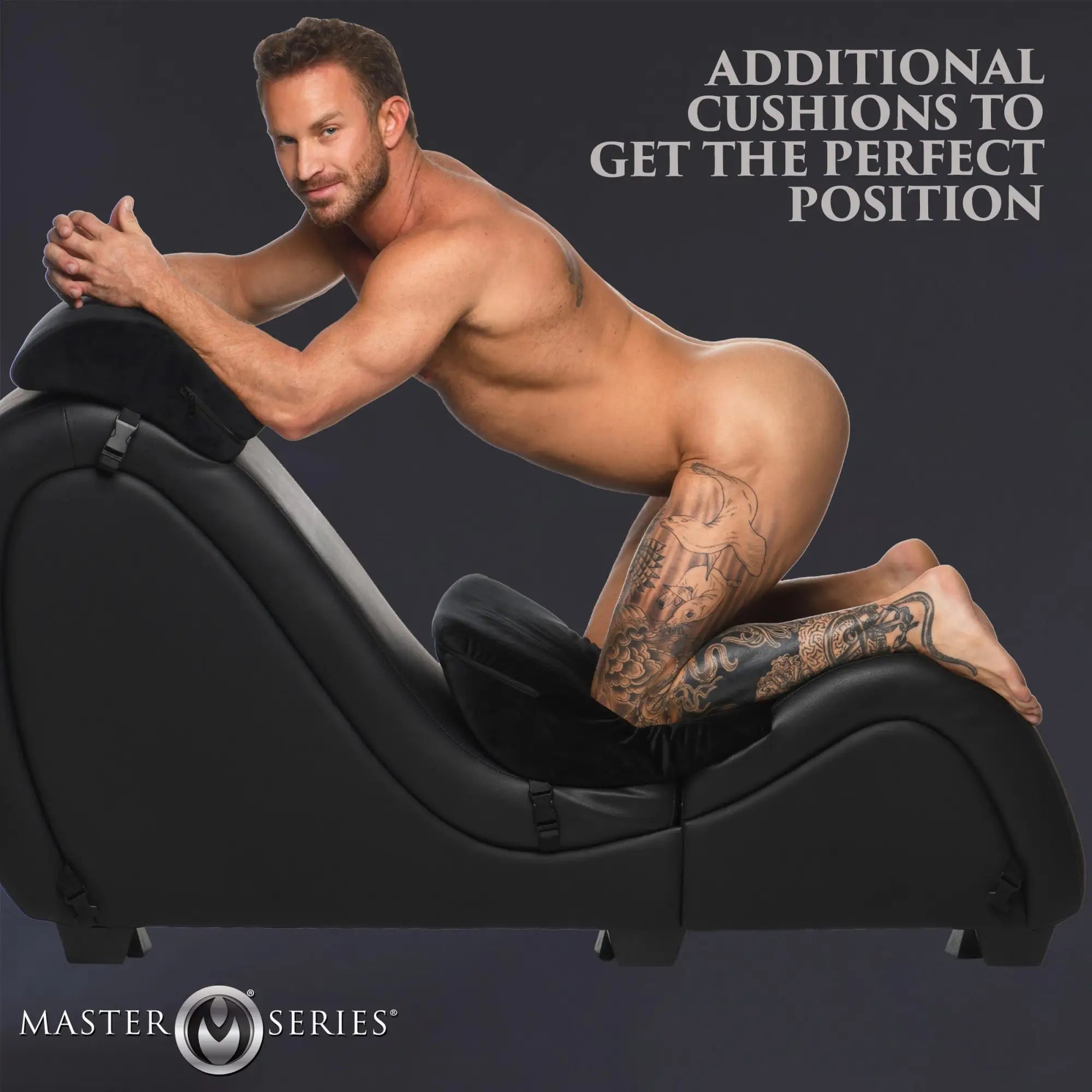 Master Series black detachable sex chaise with plush black love pillows, shown with a man in a kneeling pose.