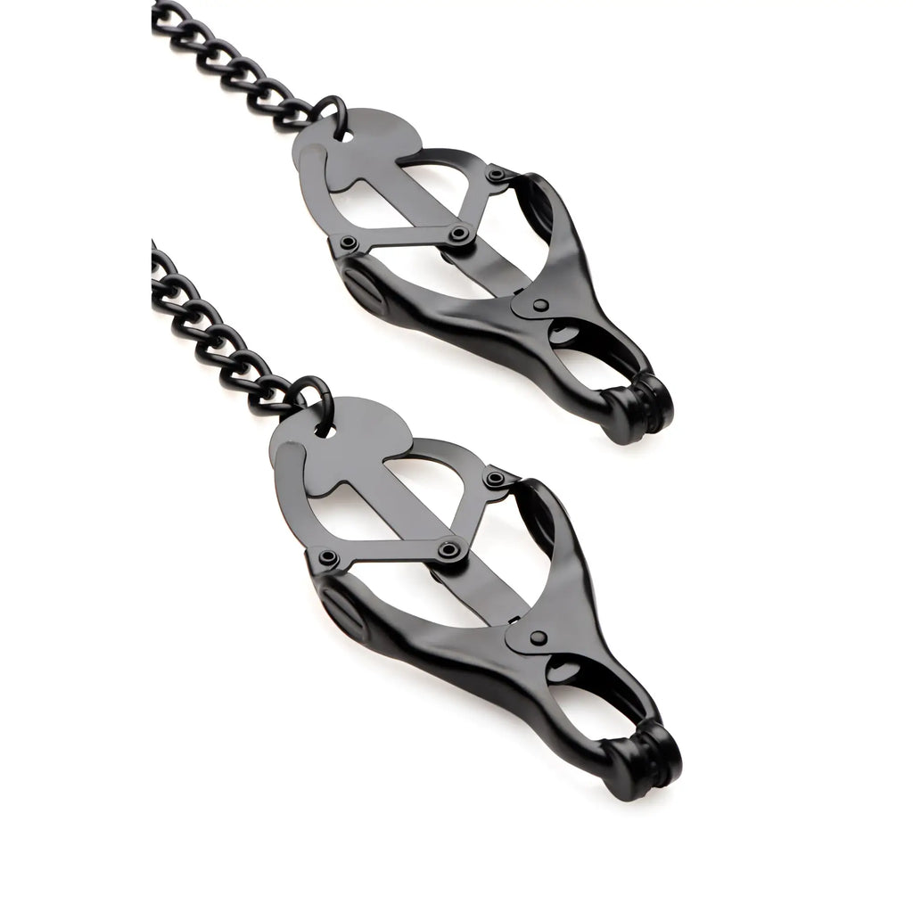 Master Series black metal Japanese-style nipple clamps connected by a matching black chain against a white background.