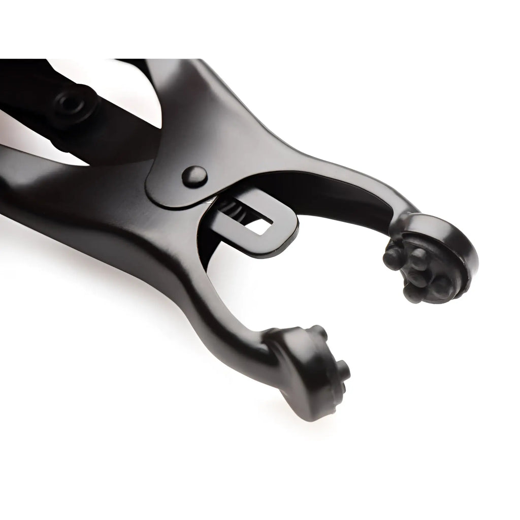 Master Series Japanese nipple clamps in matte black, featuring a spring-loaded metal design with textured tips.