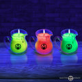 Three Master Series Blacklight Wax Play Pitchers in neon green, orange, and lime, glowing against a dark blue background.