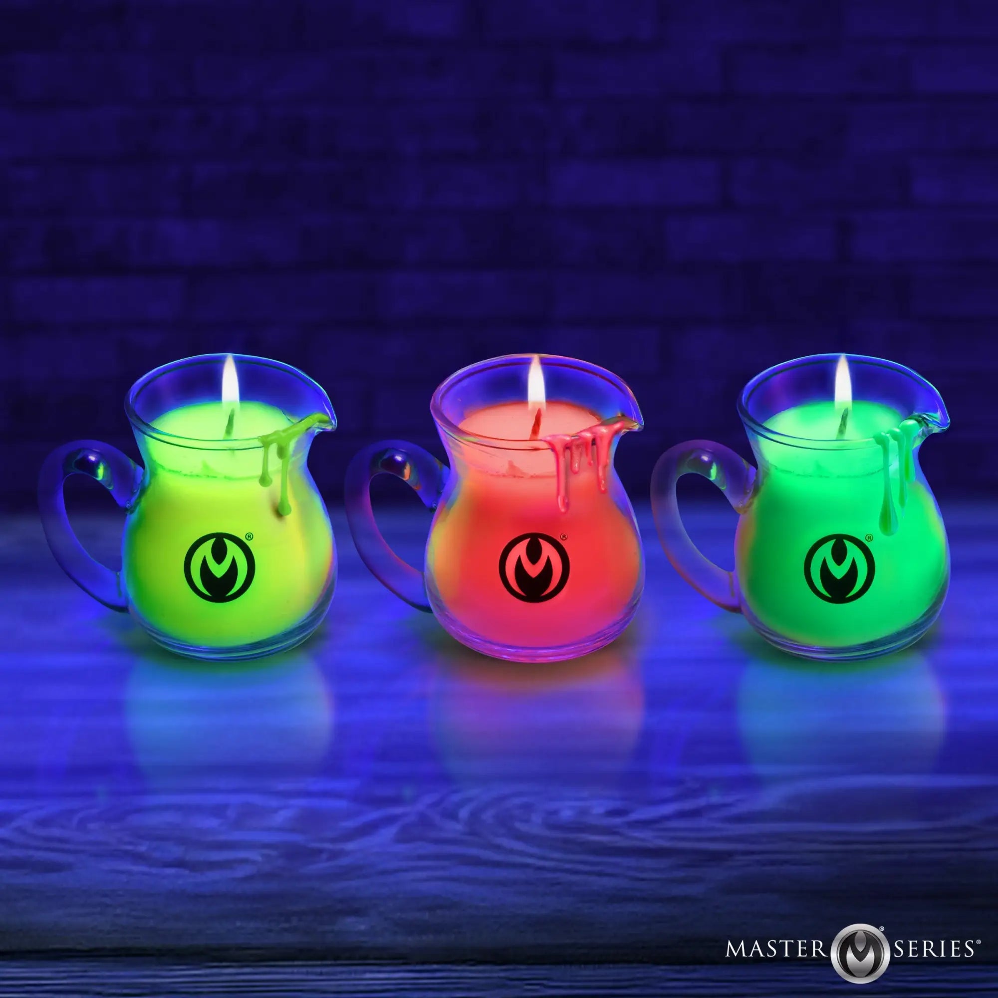 Three Master Series Blacklight Wax Play Pitchers in neon green, orange, and lime, glowing against a dark blue background.