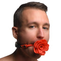 A man wearing a Master Series red silicone rose-shaped breathable gag with a black collar against a white background.