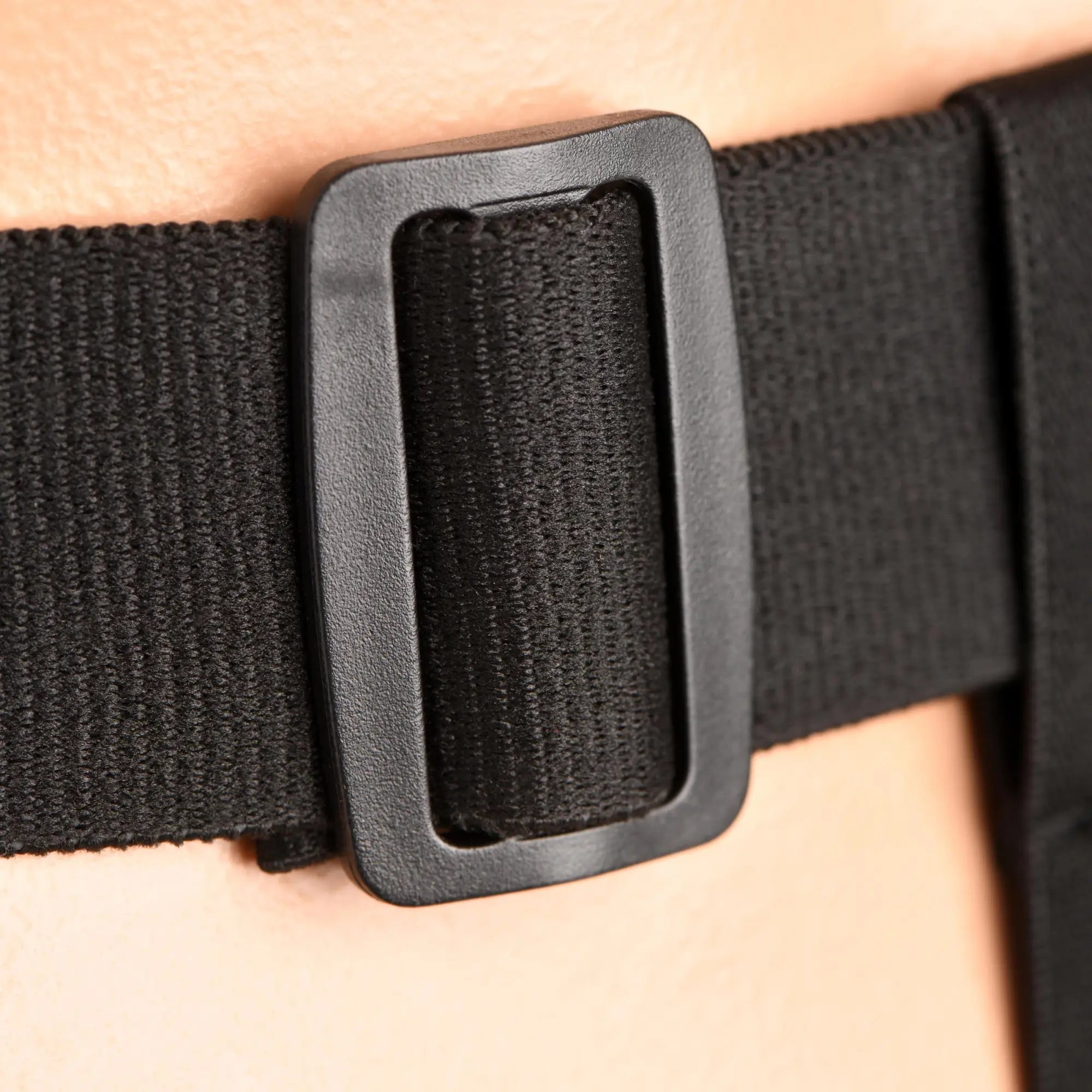 Close-up of the black elastic adjustable buckle on the Master Series Bum-Tastic Trainer Set harness strap.