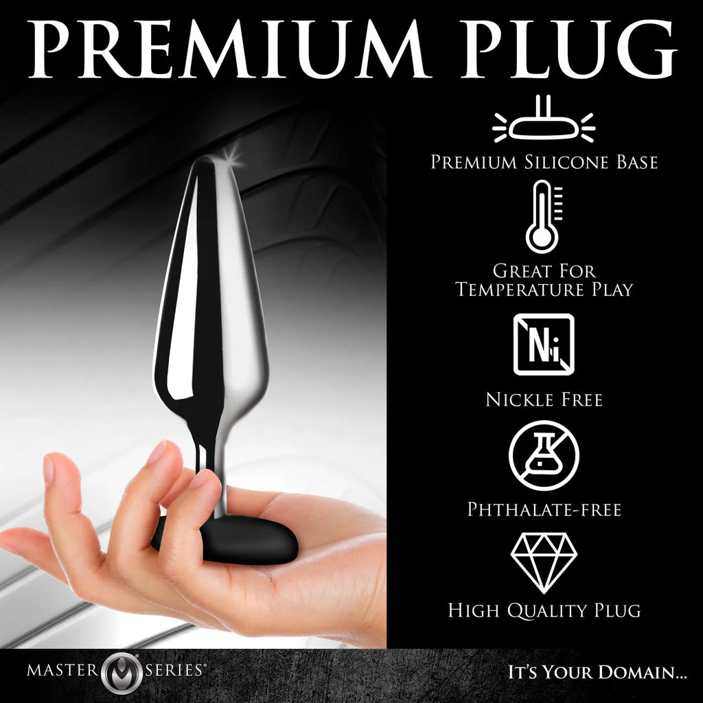 Hand holding a polished chrome Master Series metal butt plug with a matte black silicone base.