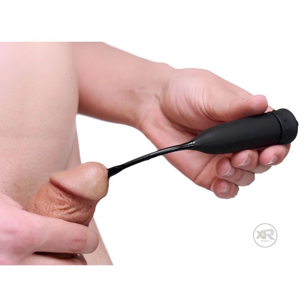 Master Series The Cadence: A black silicone vibrating urethral sound being held by a hand.