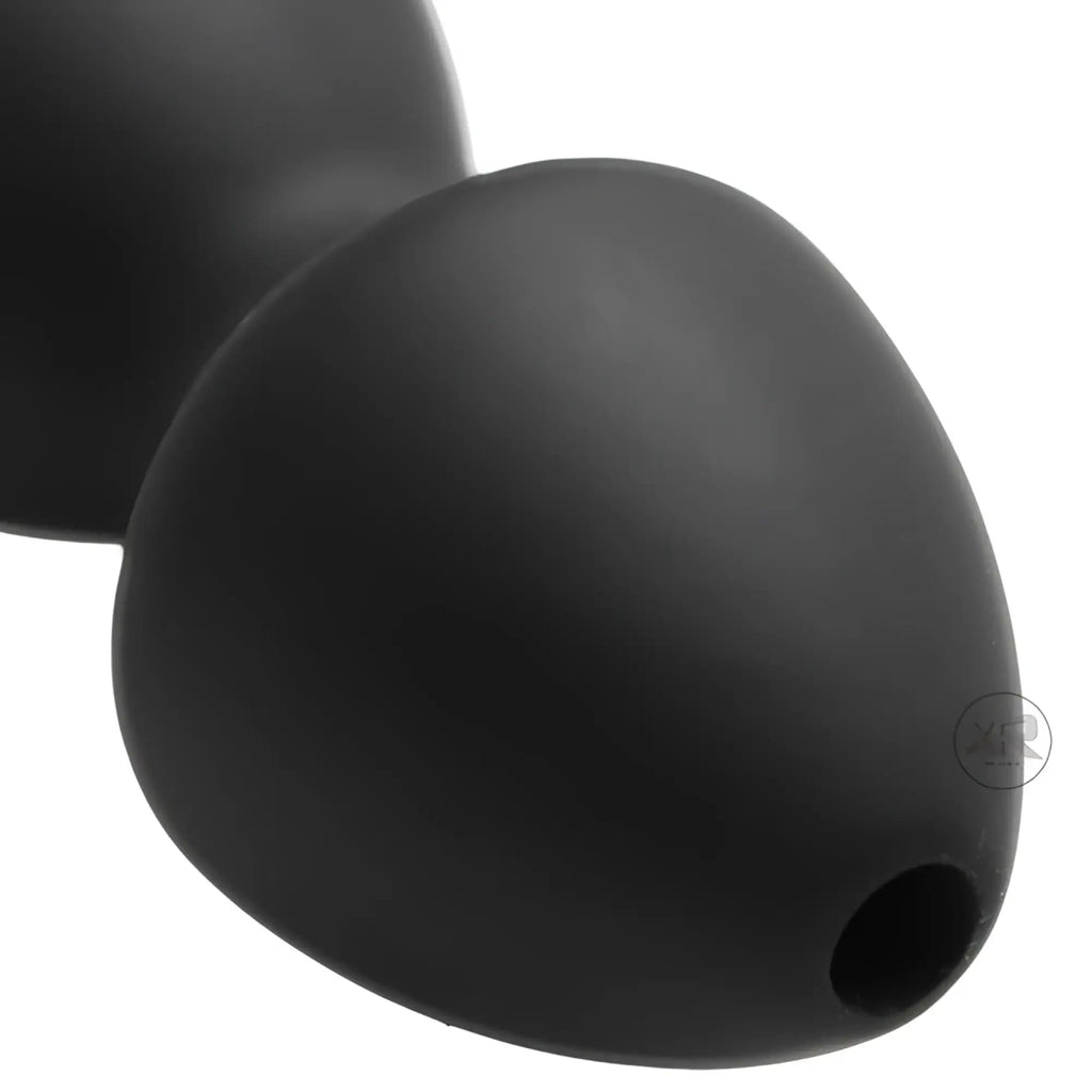 Master Series Canal Silicone Enema Attachment: A matte black, bulbous silicone plug with a center opening.