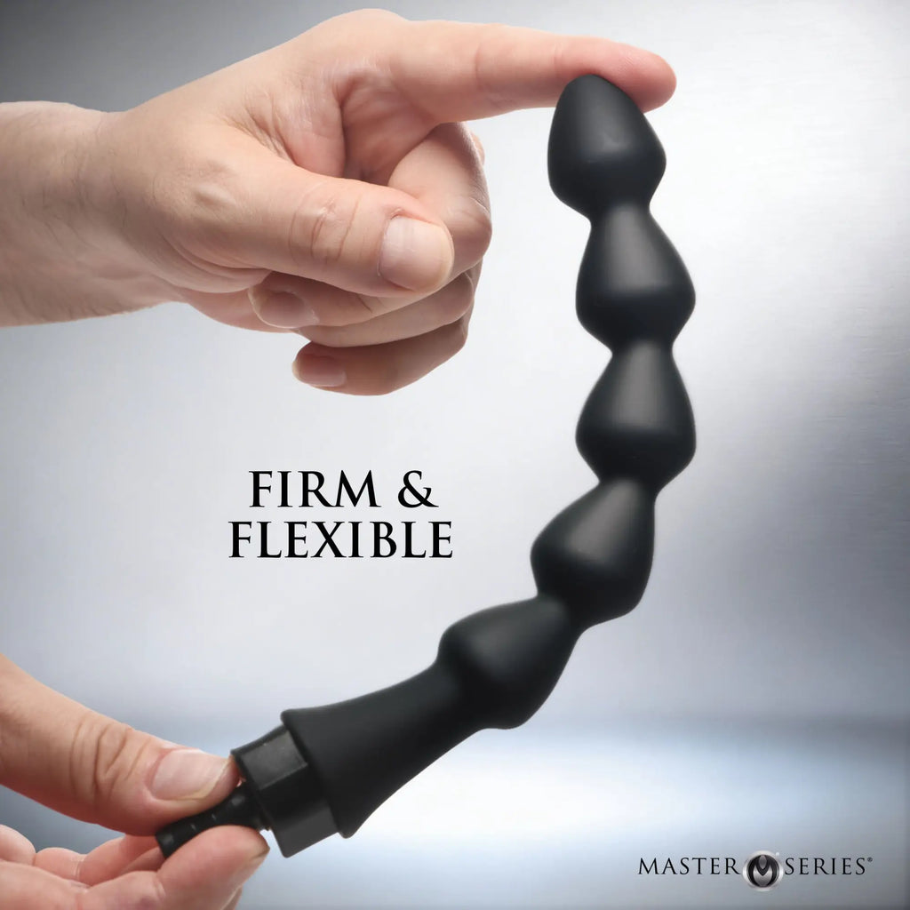 Master Series Canal black silicone enema attachment with a flexible, multi-beaded design held by a hand.
