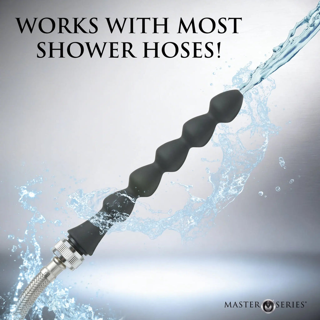 Master Series Canal silicone enema attachment: a black, multi-bead wand connected to a metal shower hose spraying water.