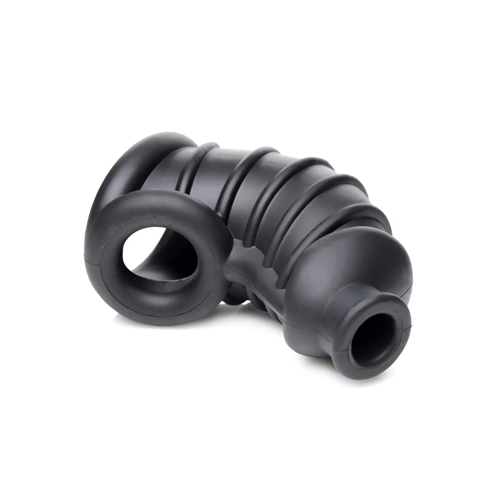 Master Series The Chamber: A black, curved silicone chastity cage with ribbed texture and a ring base.