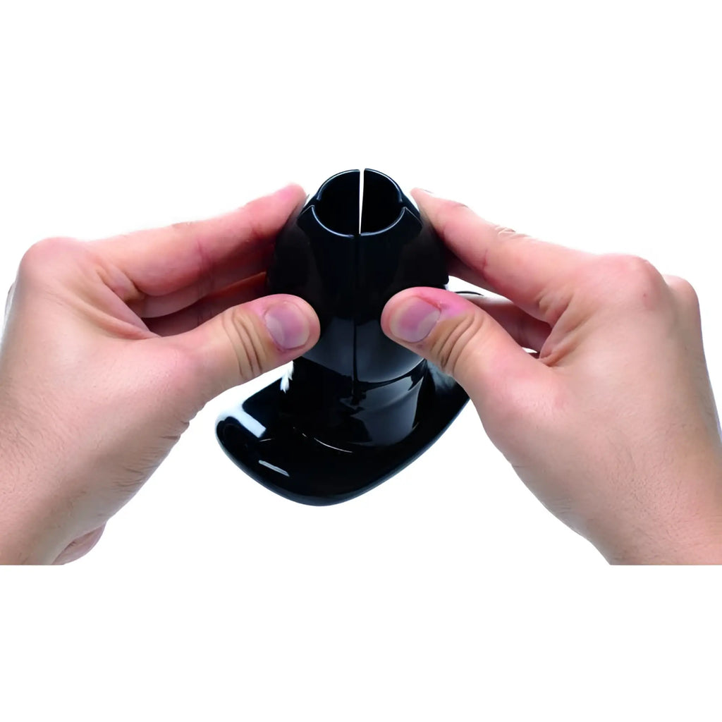 Hands holding a glossy black Master Series Claw Expanding Anal Dilator against a white background.
