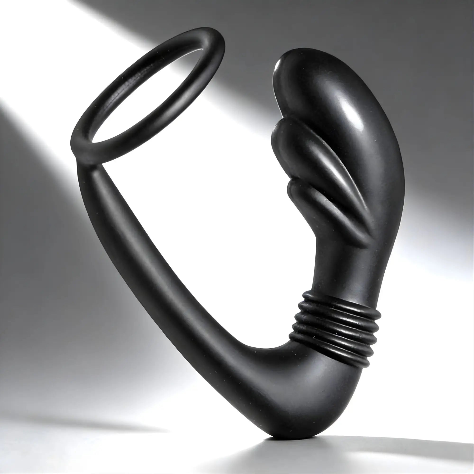 Master Series Cobra: black silicone prostate massager and cock ring with a curved, ribbed design.