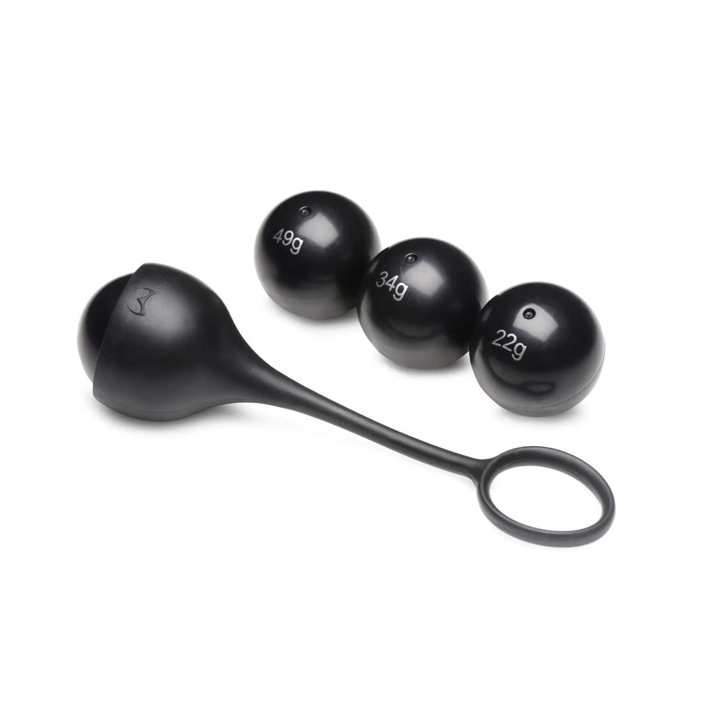 Master Series black silicone cock dangler with a ring and three interchangeable weight spheres labeled 22g, 34g, and 49g.