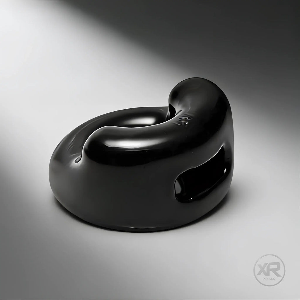 Master Series The Cock Holster: a glossy black, ergonomic silicone cock and ball ring on a grey gradient background.