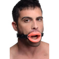 Master Series mouth gag with pink silicone lips and an adjustable black leather head strap.