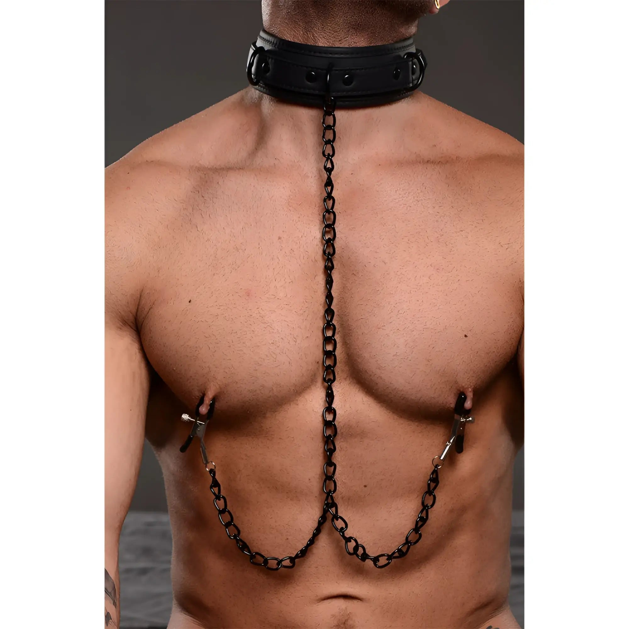 Master Series Temptress black leather collar connected by a chain to two adjustable nipple clamps on a bare male torso.