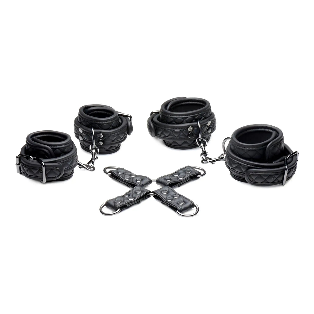 Master Series Concede black quilted leather wrist and ankle restraints with a central metal hog-tie connector.