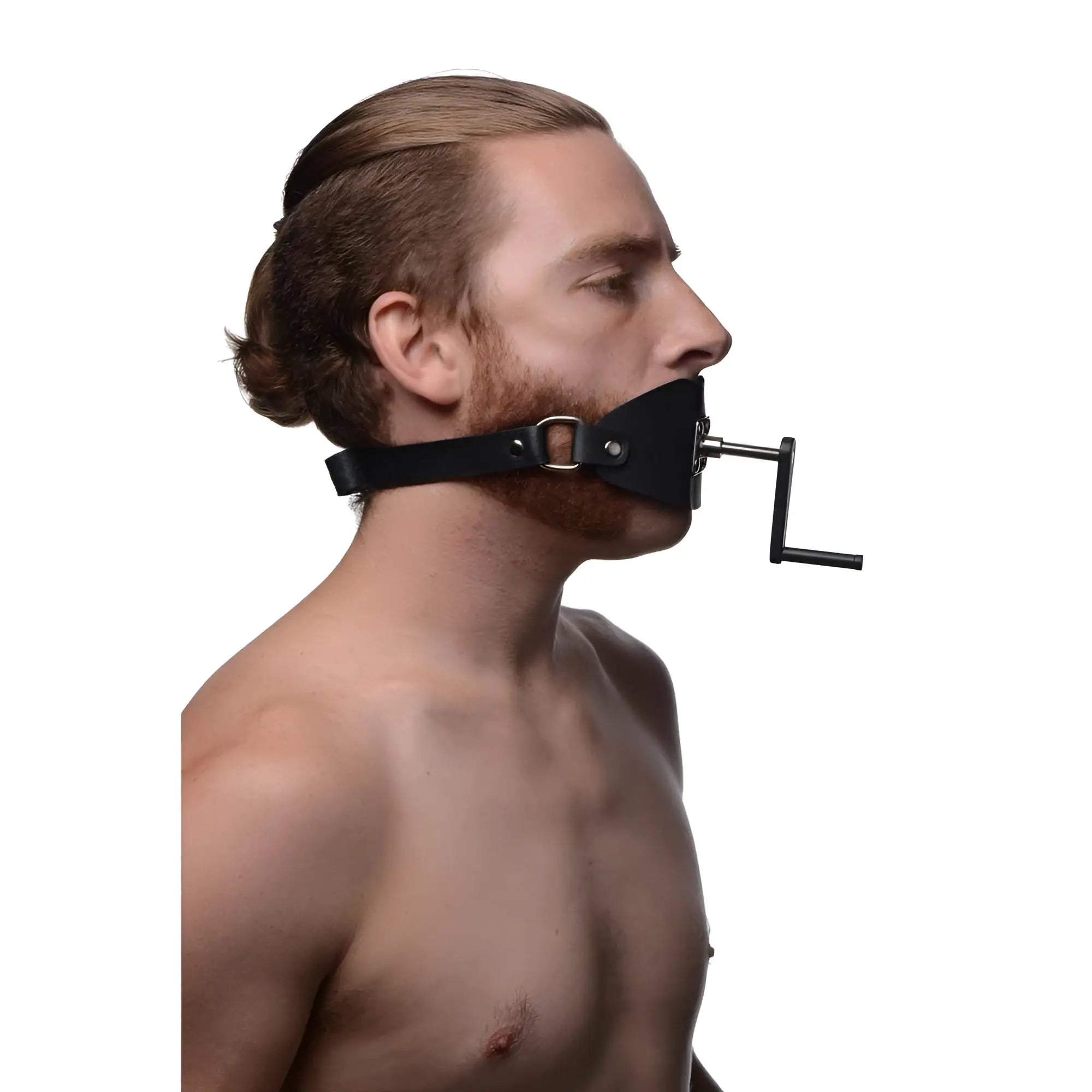 Man wearing a black leather Master Series Crank Ball Gag with a metallic handle on a white background.