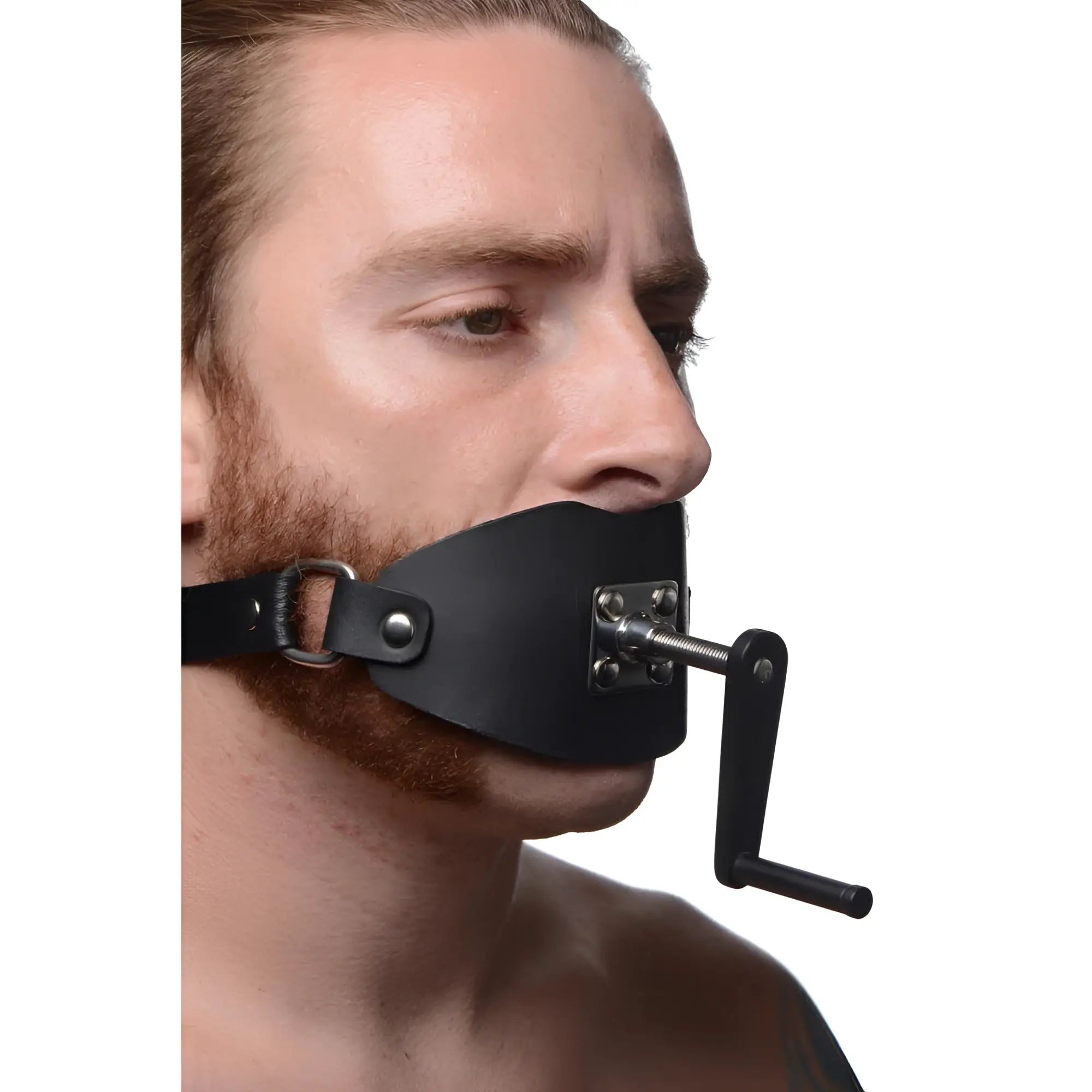 Master Series black leather crank ball gag worn by a man, featuring a metallic screw mechanism and hand crank.