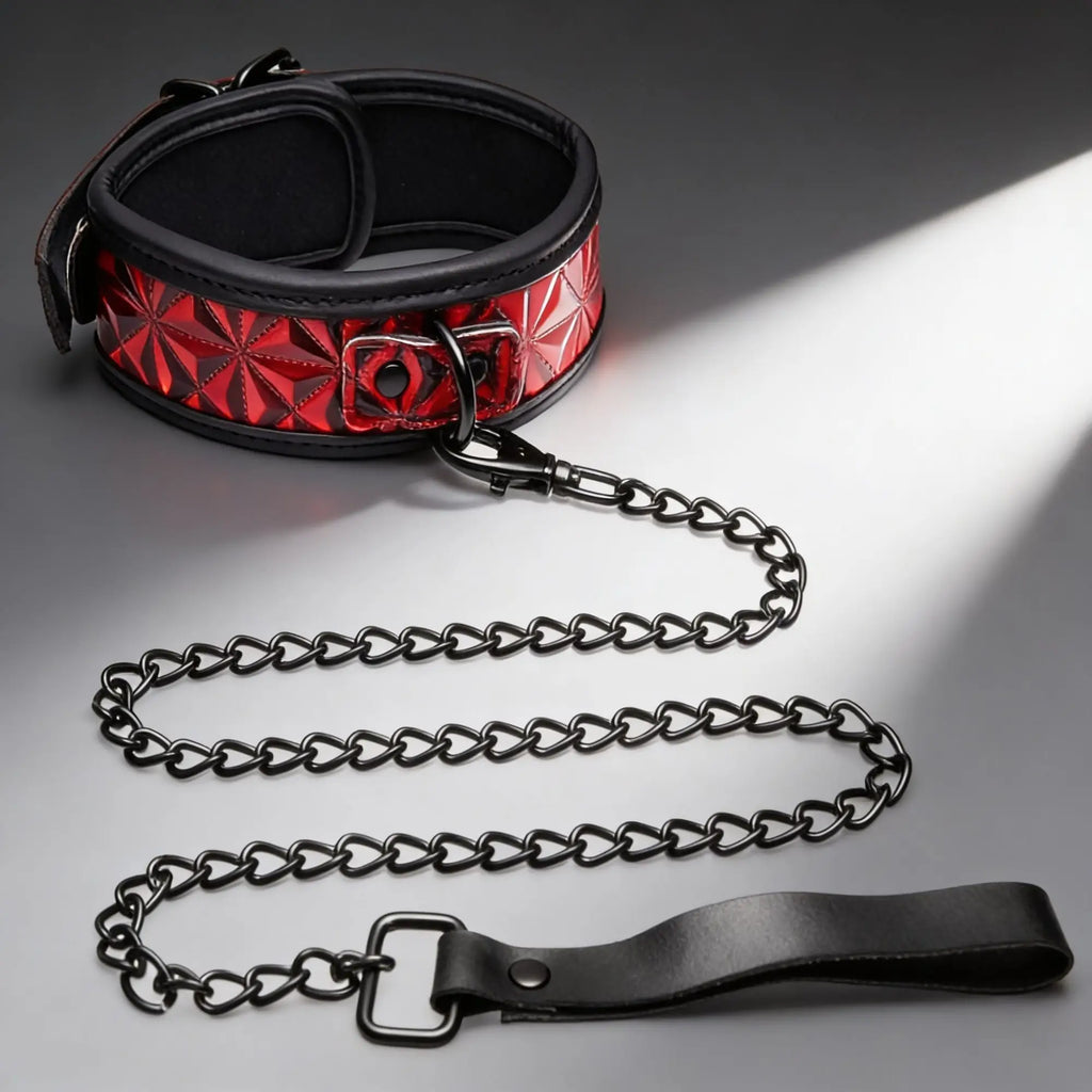 Master Series Crimson Tied collar with geometric red pattern, black trim, and matching black chain leash on grey surface.