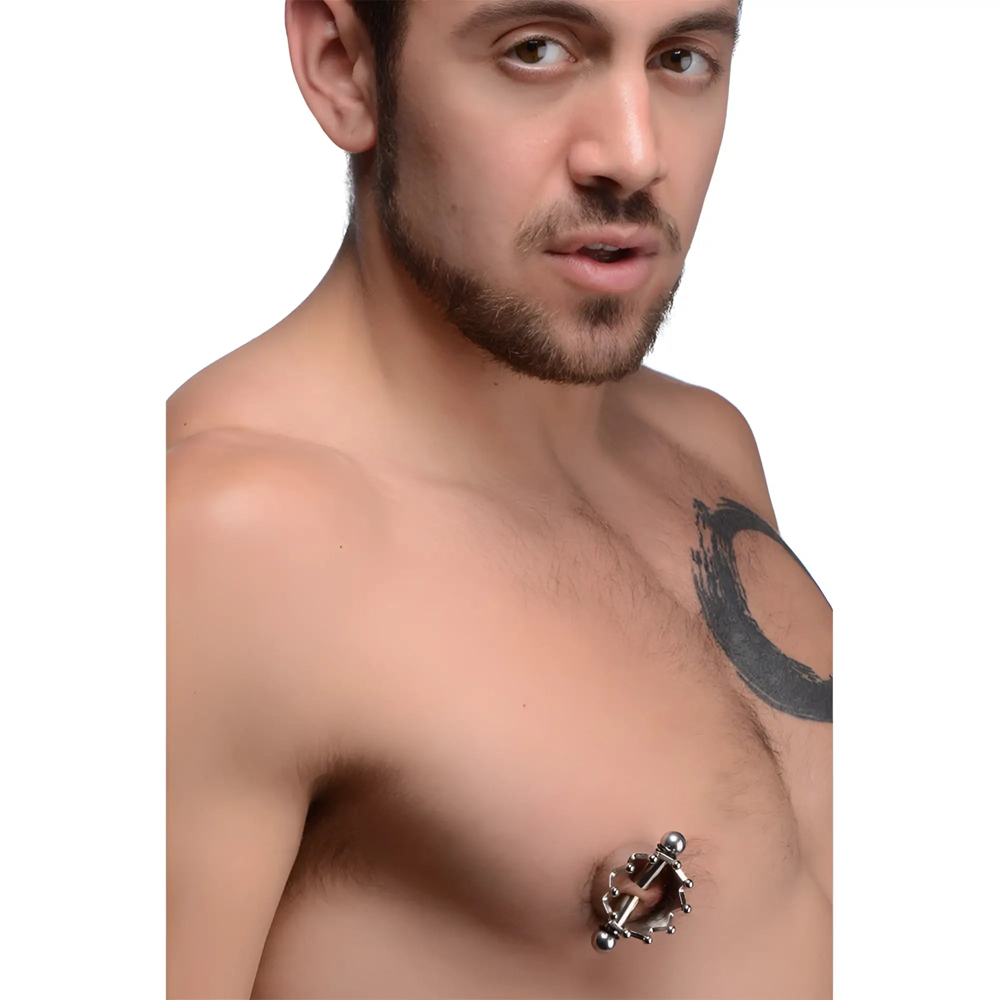 Master Series Crowned Magnetic Nipple Clamps: A silver-toned, crown-style magnetic clamp worn on a man's nipple.
