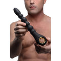 A man holding the matte black, 10-bead Master Series Dark Scepter with a gold-accented ring base.