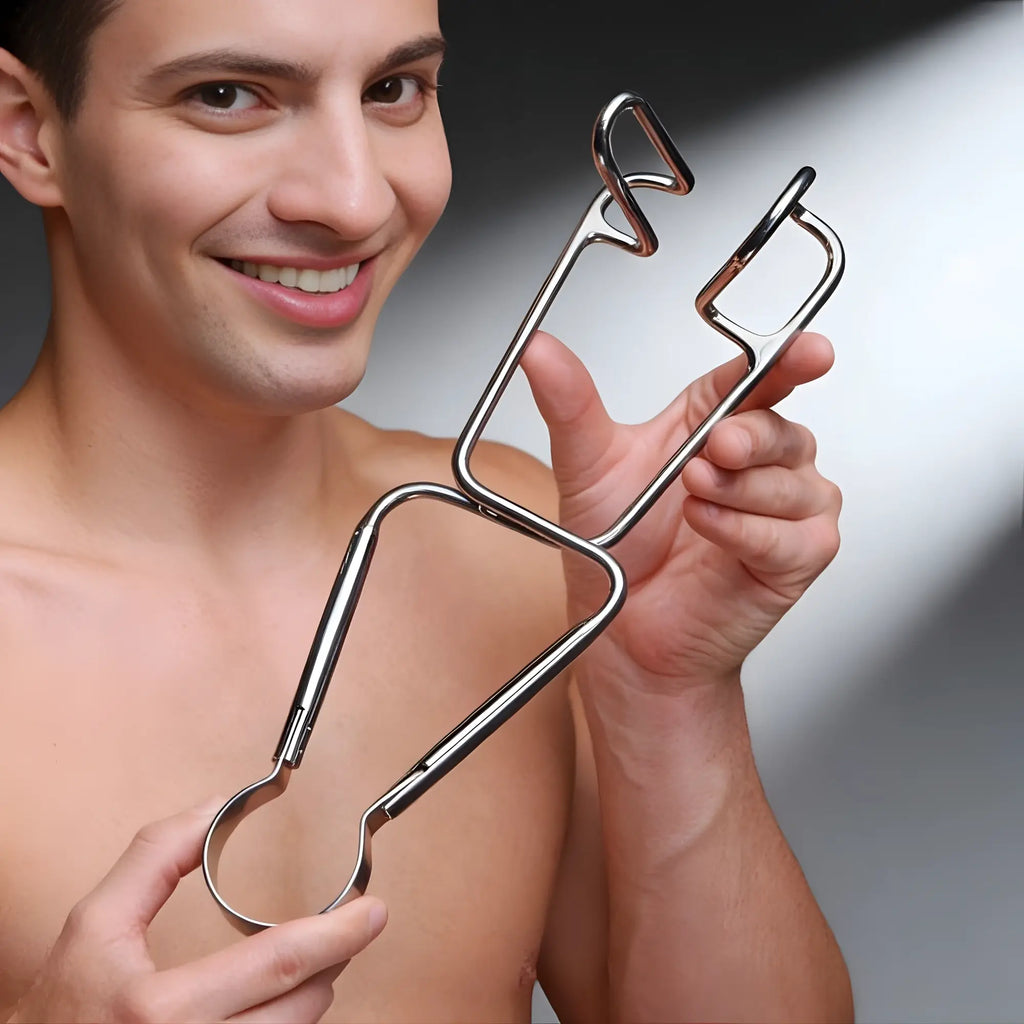 A smiling man holds a silver, metal Master Series Dartigues Retractor, a medical-style spreader tool.