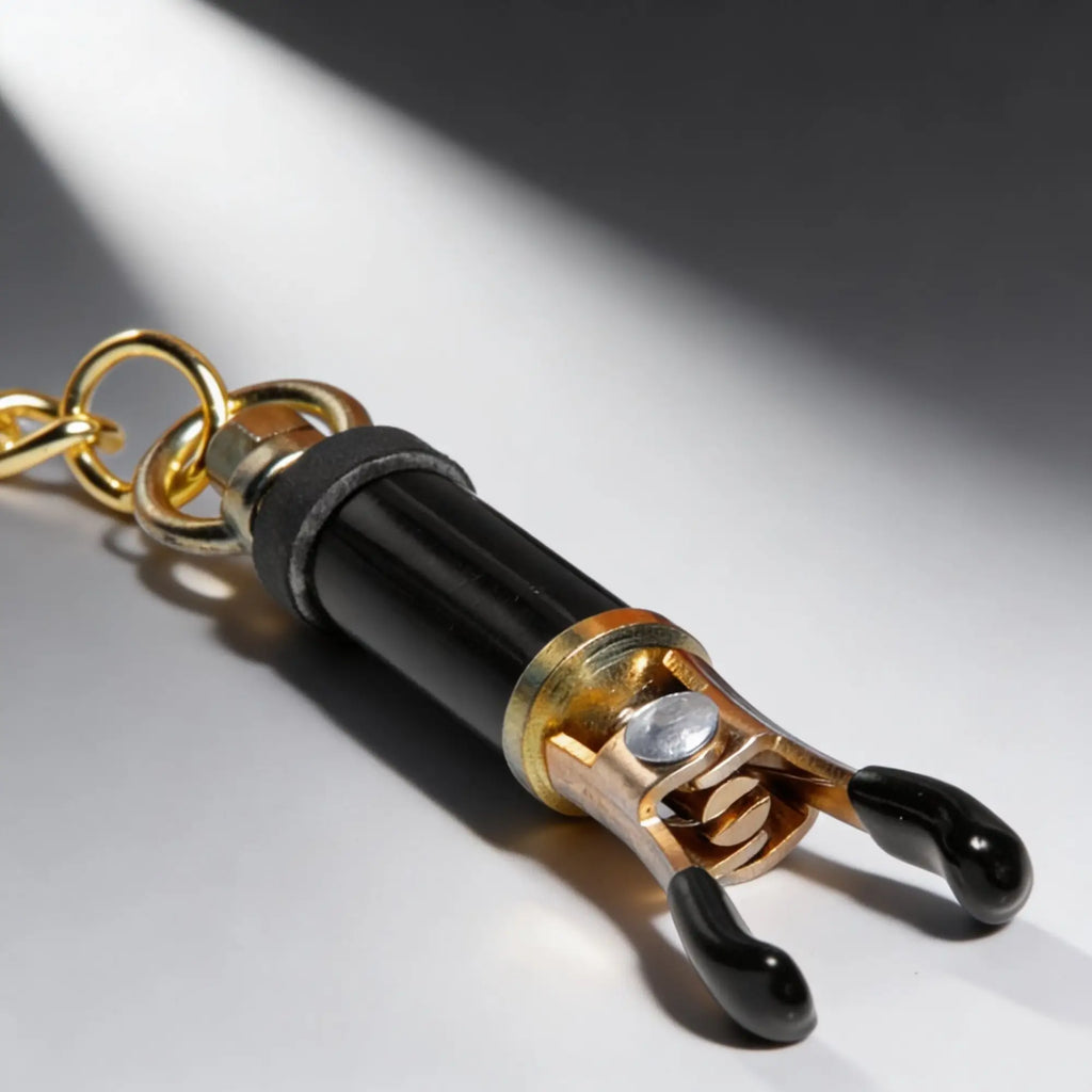 Master Series Deluxe Adjustable Nipple Clamp in gold and black with rubber-coated tips on a gold chain.