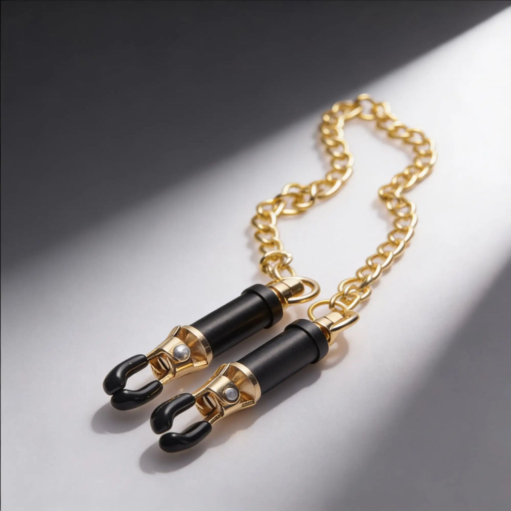 Master Series Deluxe Adjustable Nipple Clamps: Gold and black metal clamps connected by a gold chain.
