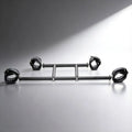 Master Series Deluxe black metal spreader bar with four adjustable padded leather wrist and ankle cuffs.