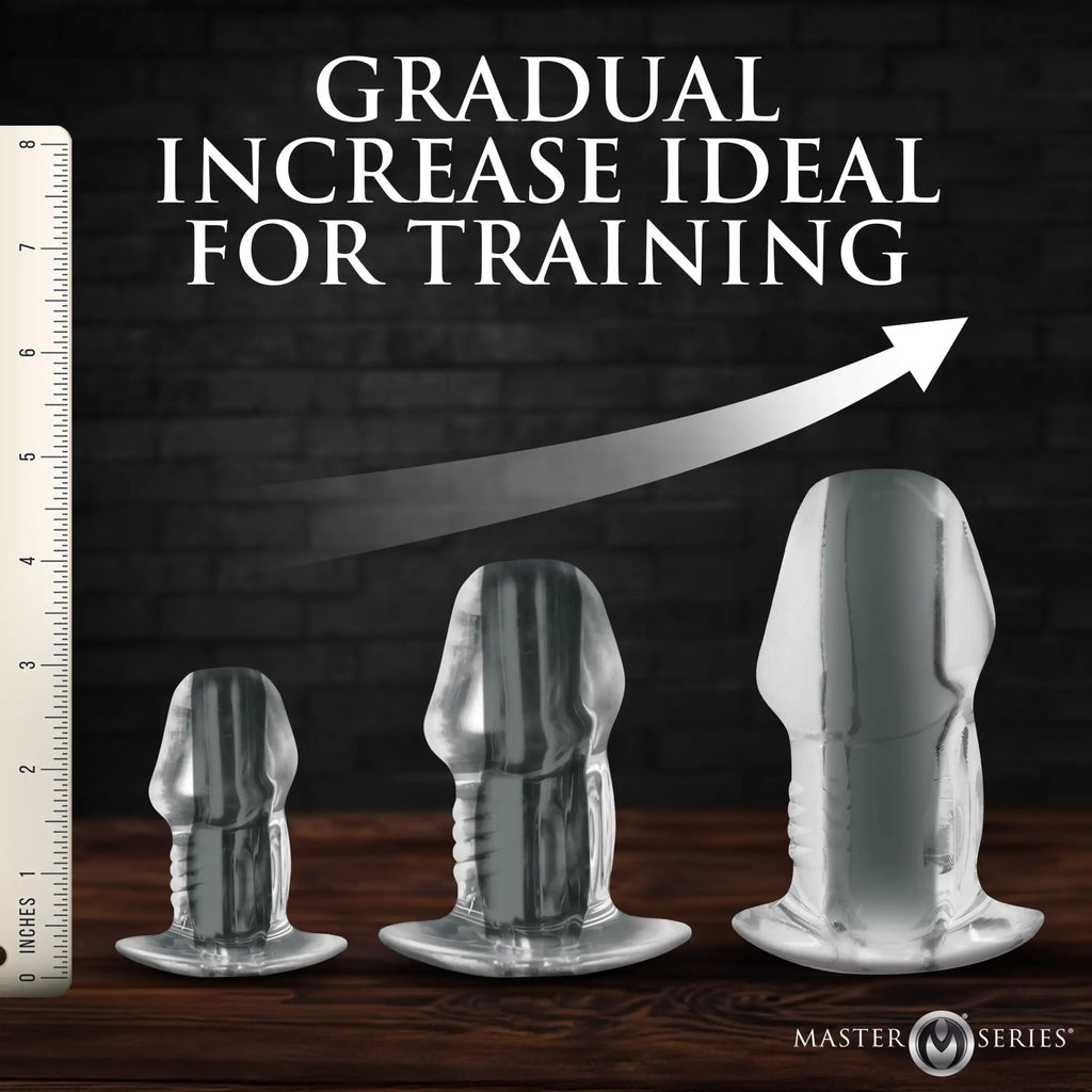 Master Series 3pc clear hollow anal plug set, featuring phallic-shaped, graduated sizes next to a ruler for scale.