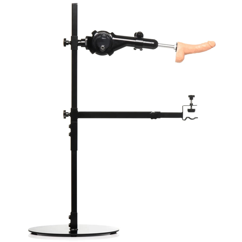 Master Series The Dicktator 2.0 sex machine: a black metal stand with a motorized arm and a flesh-toned phallic attachment.