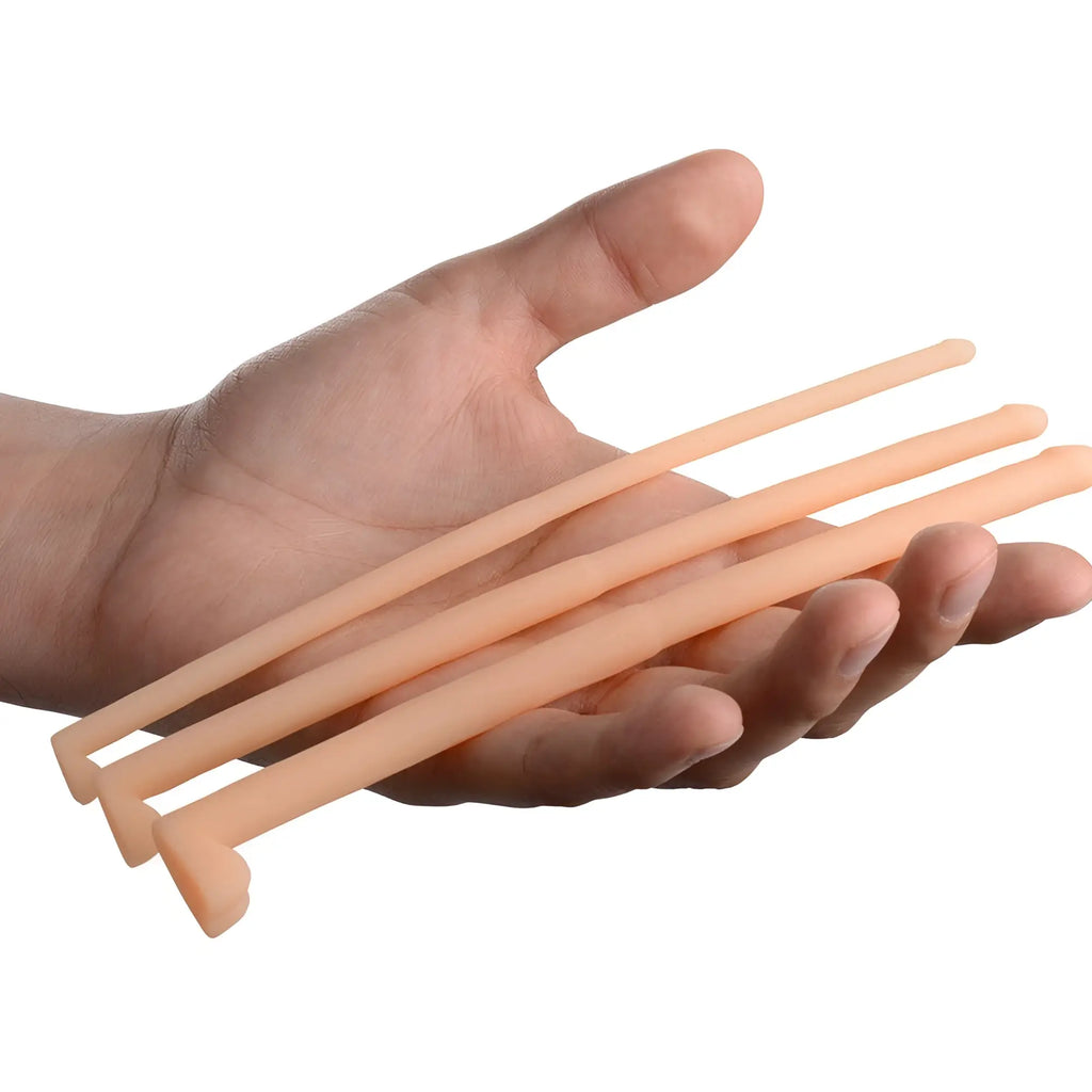 Master Series Dockers: three smooth, peach-colored silicone urethral sounds of varying widths held in an open palm.