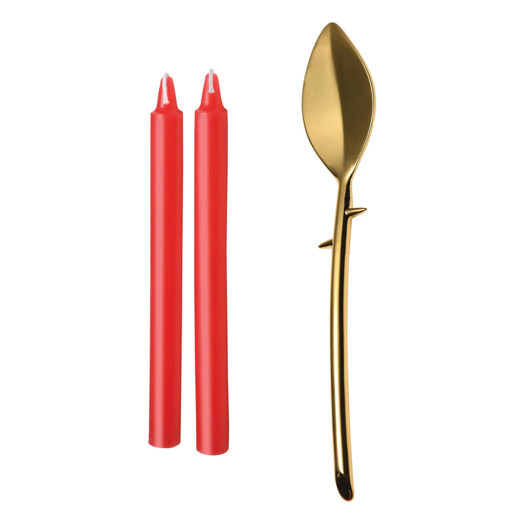 Master Series Drip Sensation set includes two red waxplay candles and a gold-toned, thorn-stemmed metal scraper.