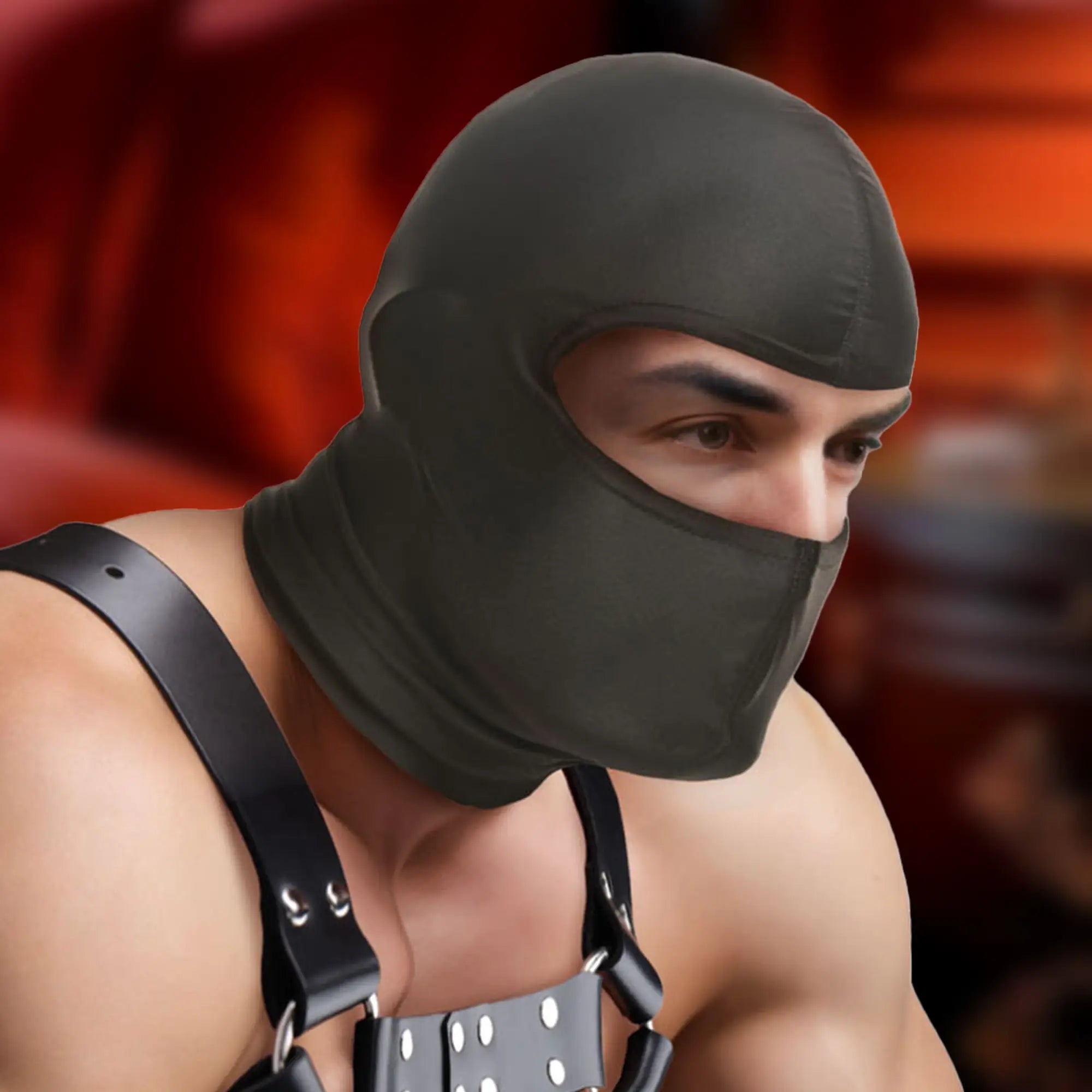 Master Series The Drone Hood: A smooth black full-head mask with an open eye and nose area, worn with leather harness.