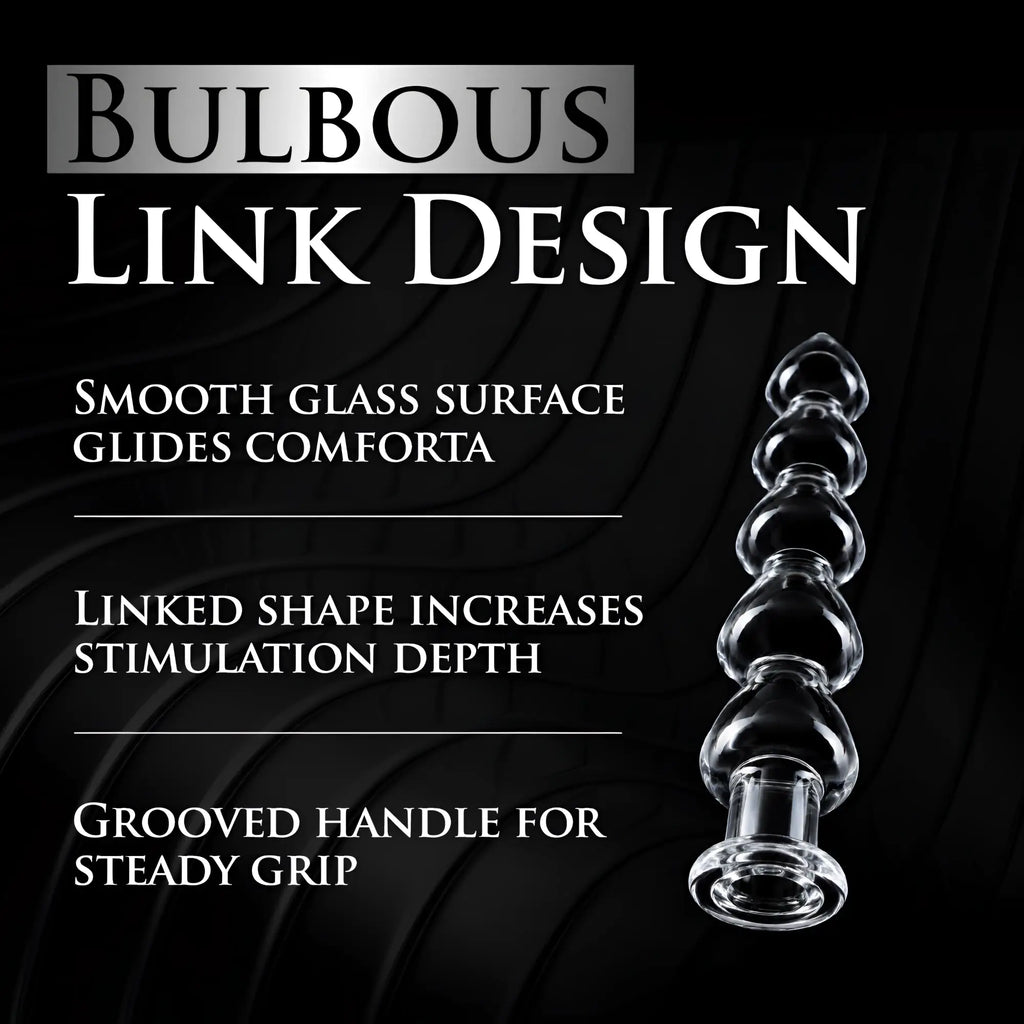Master Series Drops Anal Link glass dildo with a clear, bulbous design and grooved handle against a black background.