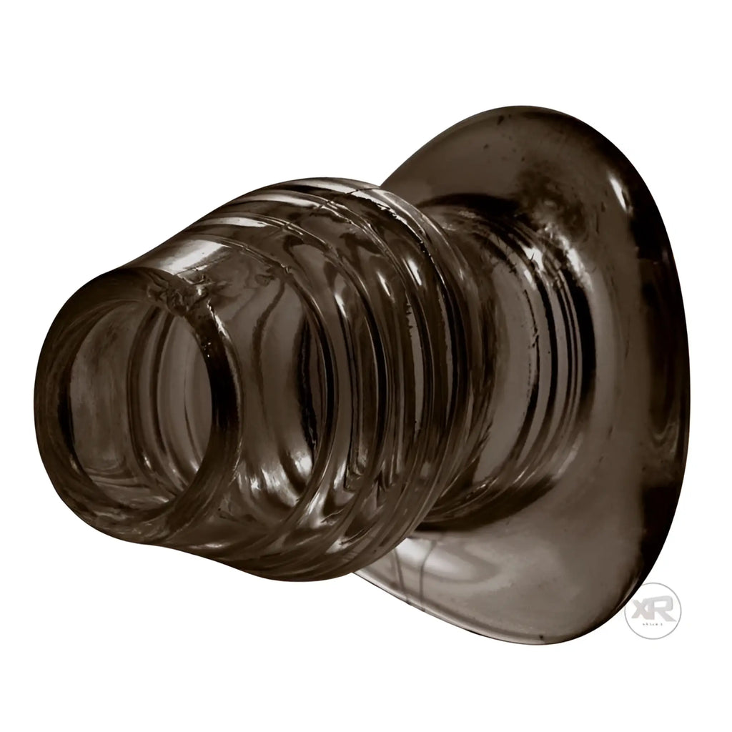 Master Series Excavate Tunnel Anal Plug: A translucent, dark grey, hollow ribbed plug with a wide, flared base.