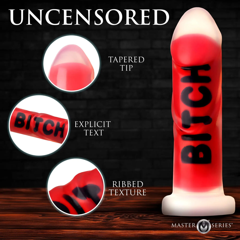 Master Series Explicit Text dildo: a red silicone toy with a tapered tip, ribbed texture, and black text detail.