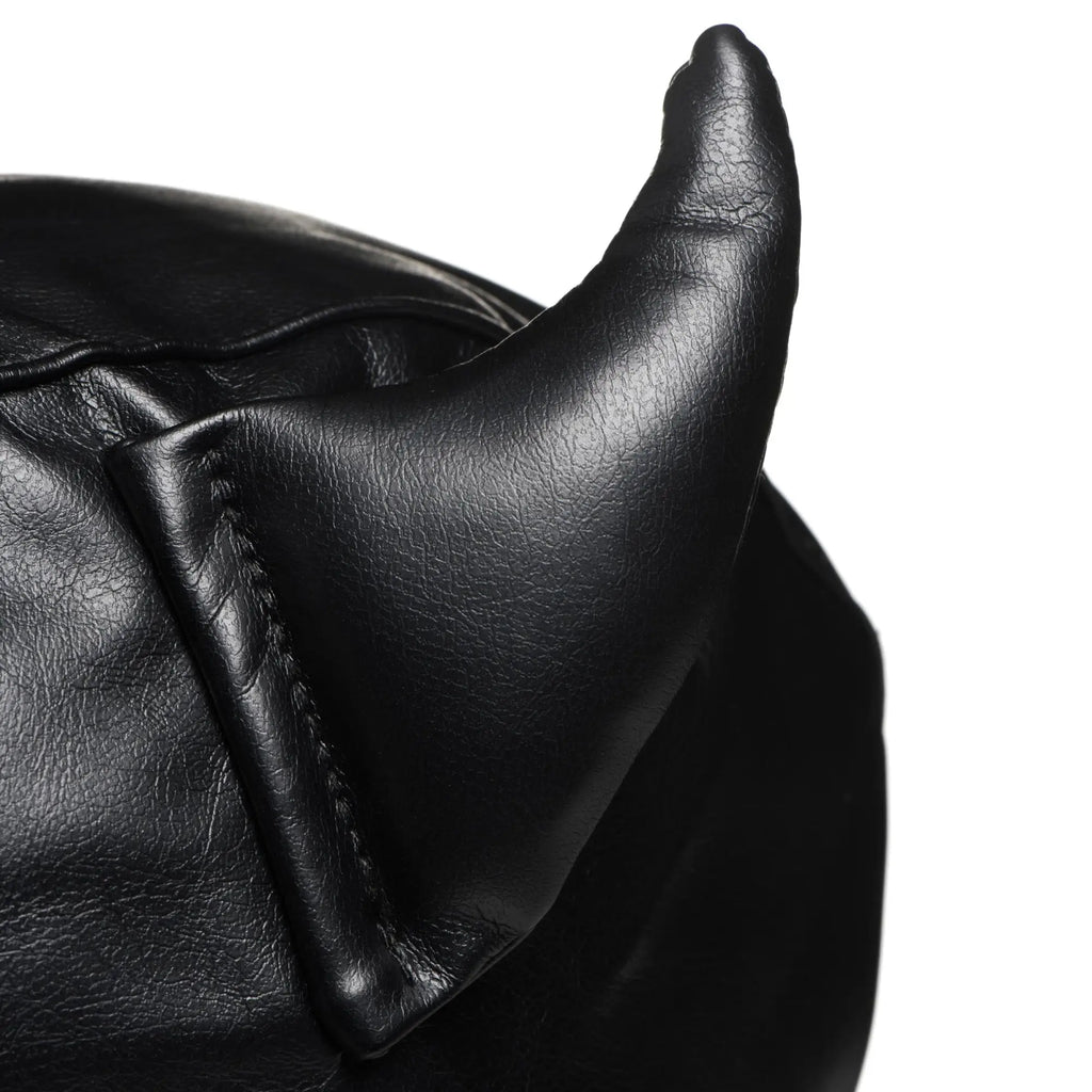 Close-up of a black Master Series Fetish Hood showing a stitched, curved leather horn on a textured leather background.