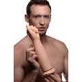 Man holding a beige, realistic Master Series Fisto clenched fist dildo against a white background.