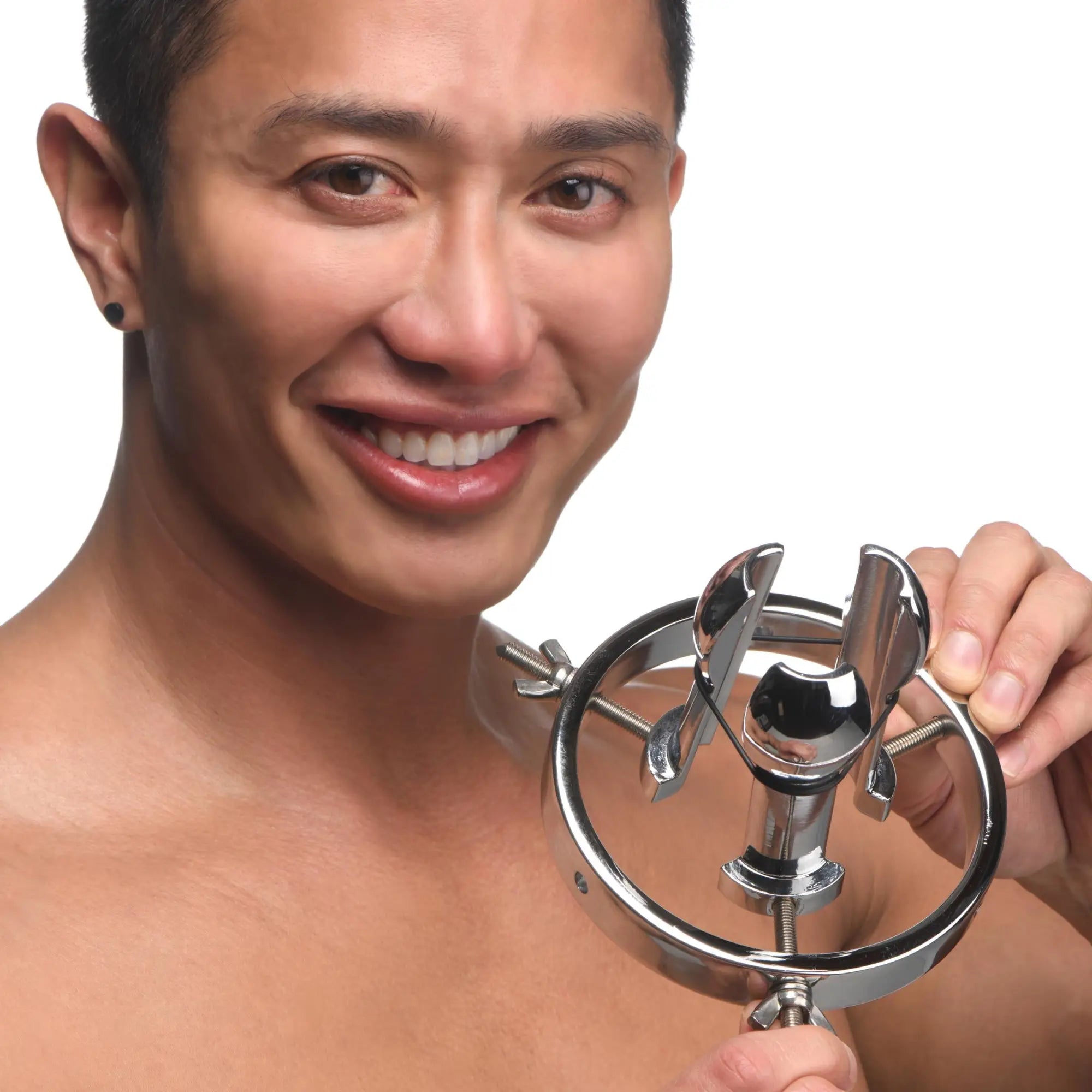 A smiling man holds a silver, stainless steel Master Series Forced Spread Anal Explorer with an adjustable ring design.