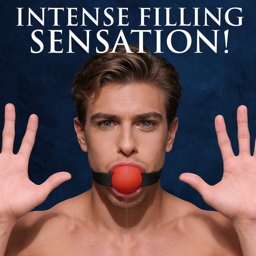 Master Series Gag Order silicone ball gag: a man wearing a red ball gag with a black strap, hands raised, blue backdrop.