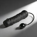 Master Series Giant Inflatable Solid Core Dildo: A textured, black, phallic-shaped toy with a connected air pump bulb.