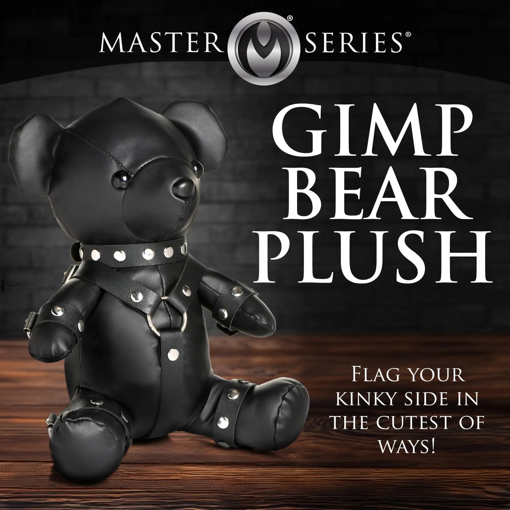 Master Series Gimp Teddy Bear in black faux leather, wearing a studded collar and matching harness with silver accents.