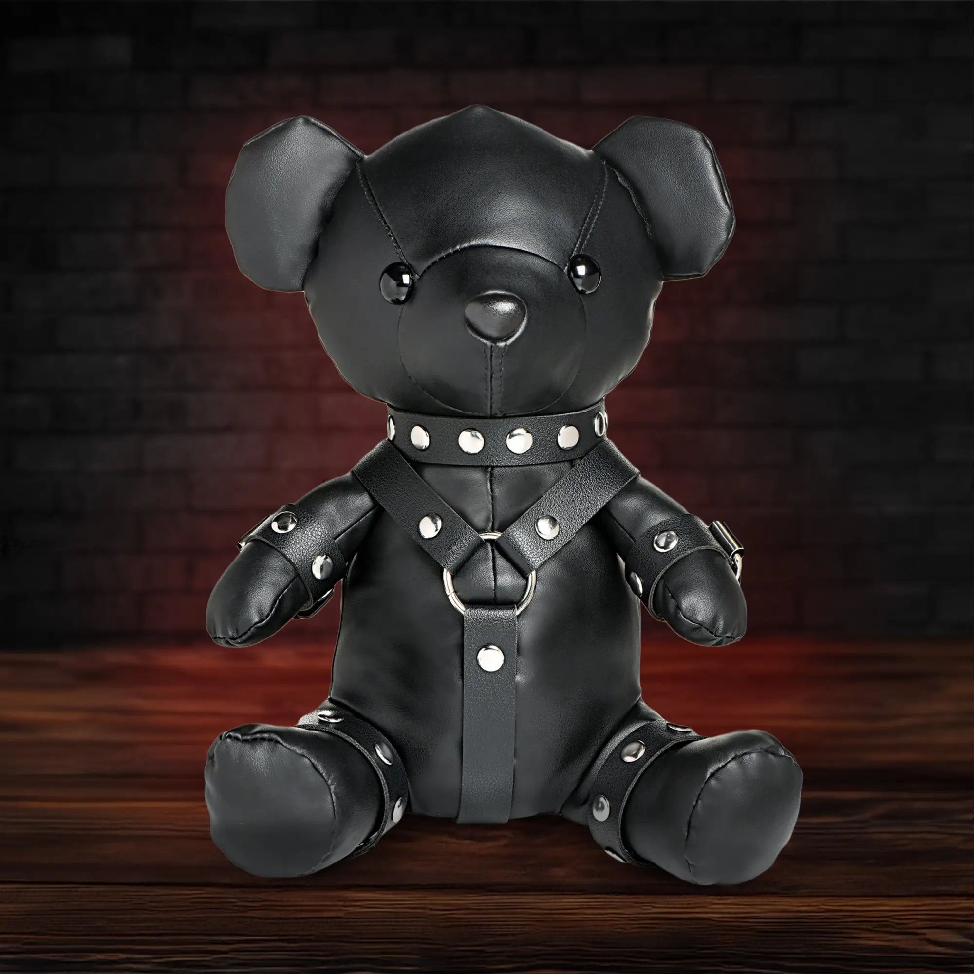 Master Series Gimp Teddy Bear: A black faux-leather plush toy wearing a matching harness, collar, and limb straps.